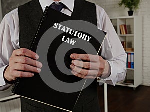 Attorney holds STATUTORY LAW book. Statutory lawÂ orÂ statute lawÂ is writtenÂ lawÂ passed by a body of legislature